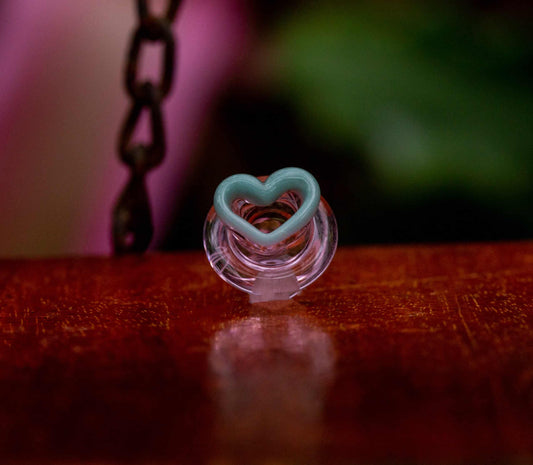 trendy design of the (SP3) Transparent Pink / Teal Heart Puffco Peak Carb Cap by Sakibomb